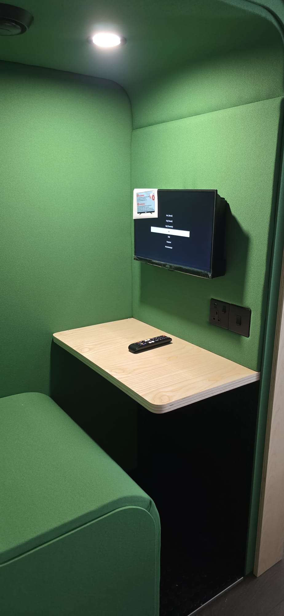 Dapapod booth interior with custom lotus flower print and blue wool seats