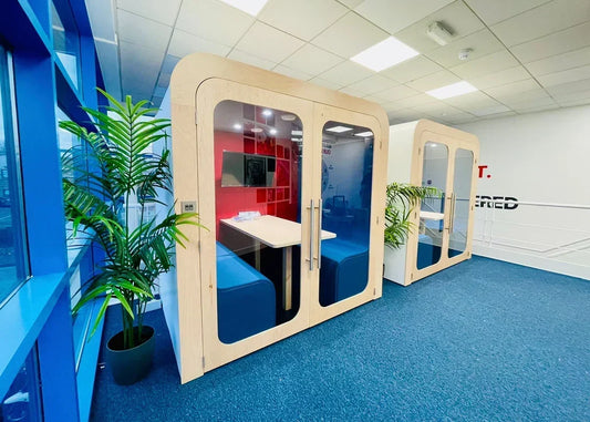 Two wooden Dapapod meeting pods installed in a modern office