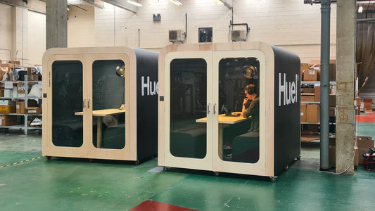 Two Huel branded Dapapod office meeting pods in a workspace