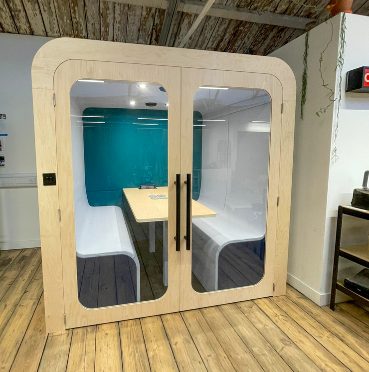 Dapapod acoustic meeting booth with teal and blue wool interior and birch ply frame