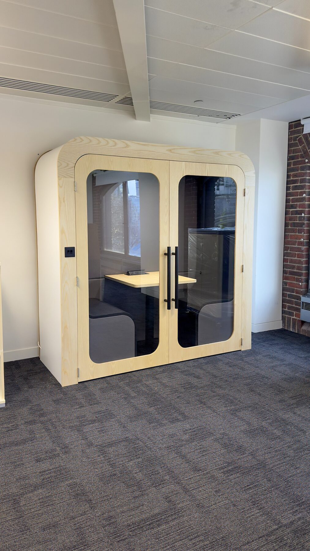 Dapapod double pod in an office with exposed beams and brickwork