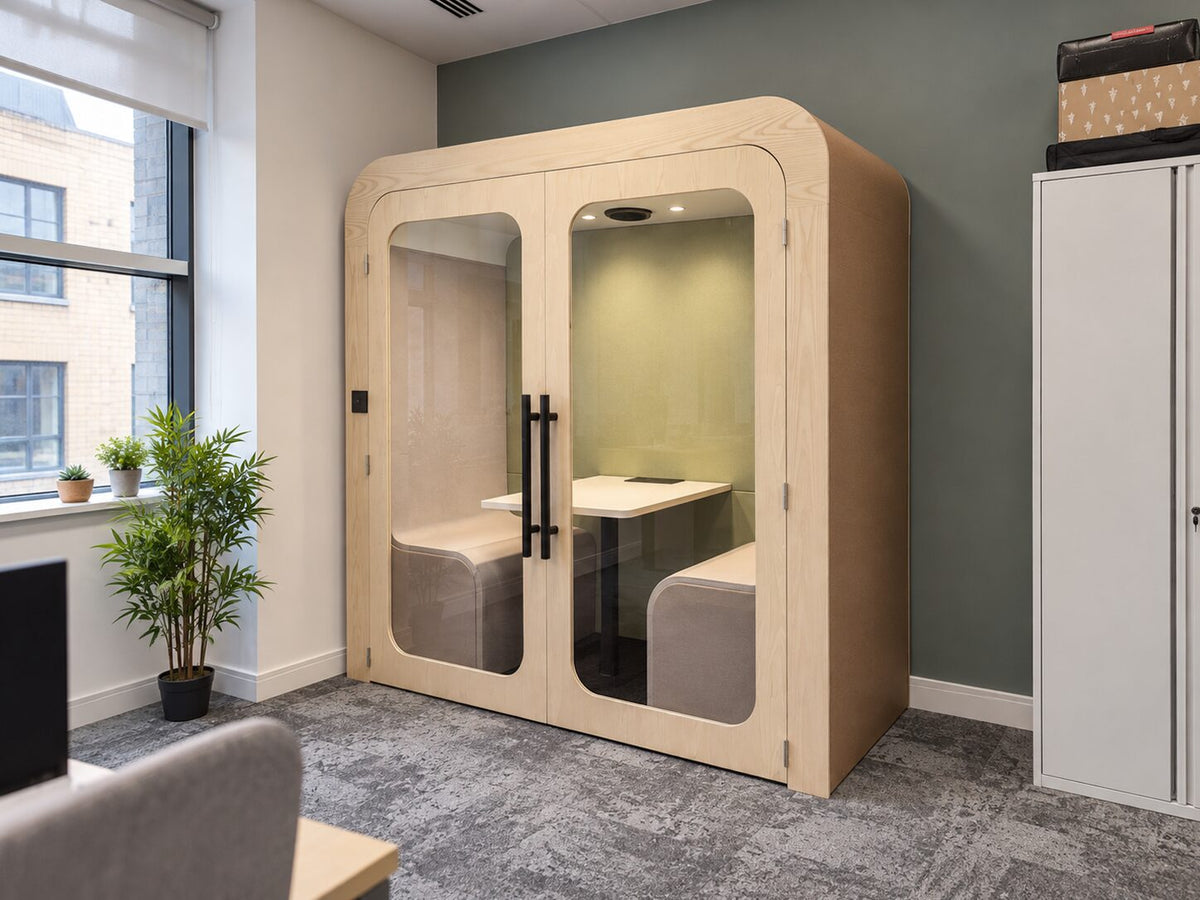 Dapapod double pod with pale green interior beside an office window