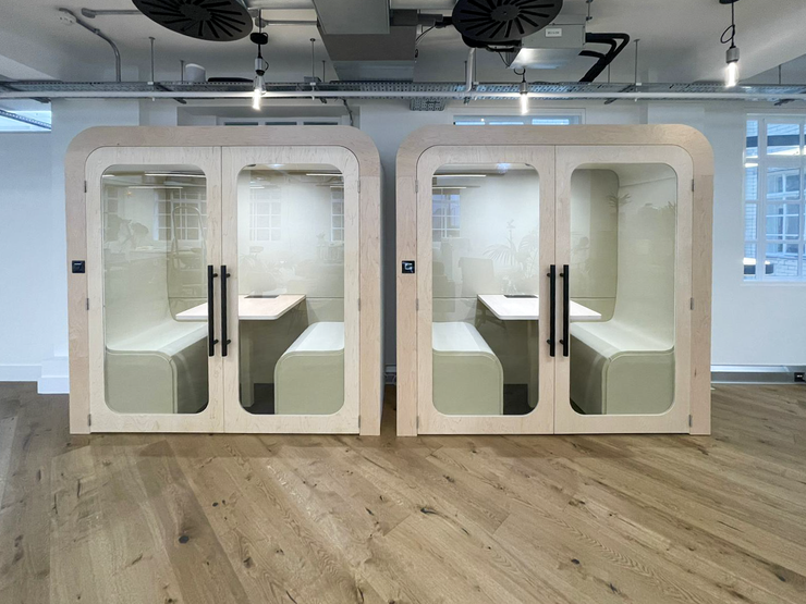 Two matching Dapapod meeting booths with white wool interiors on an oak floor