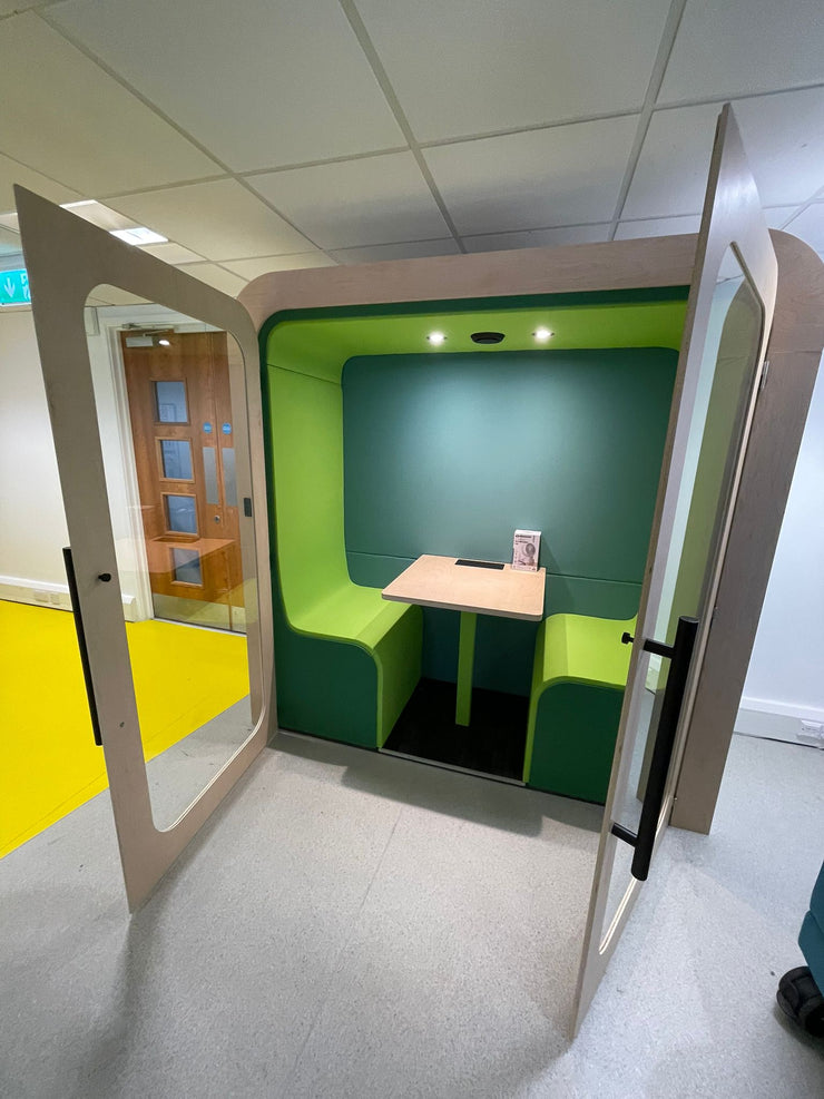Dapapod meeting booth with lime and forest green wool interior, doors open