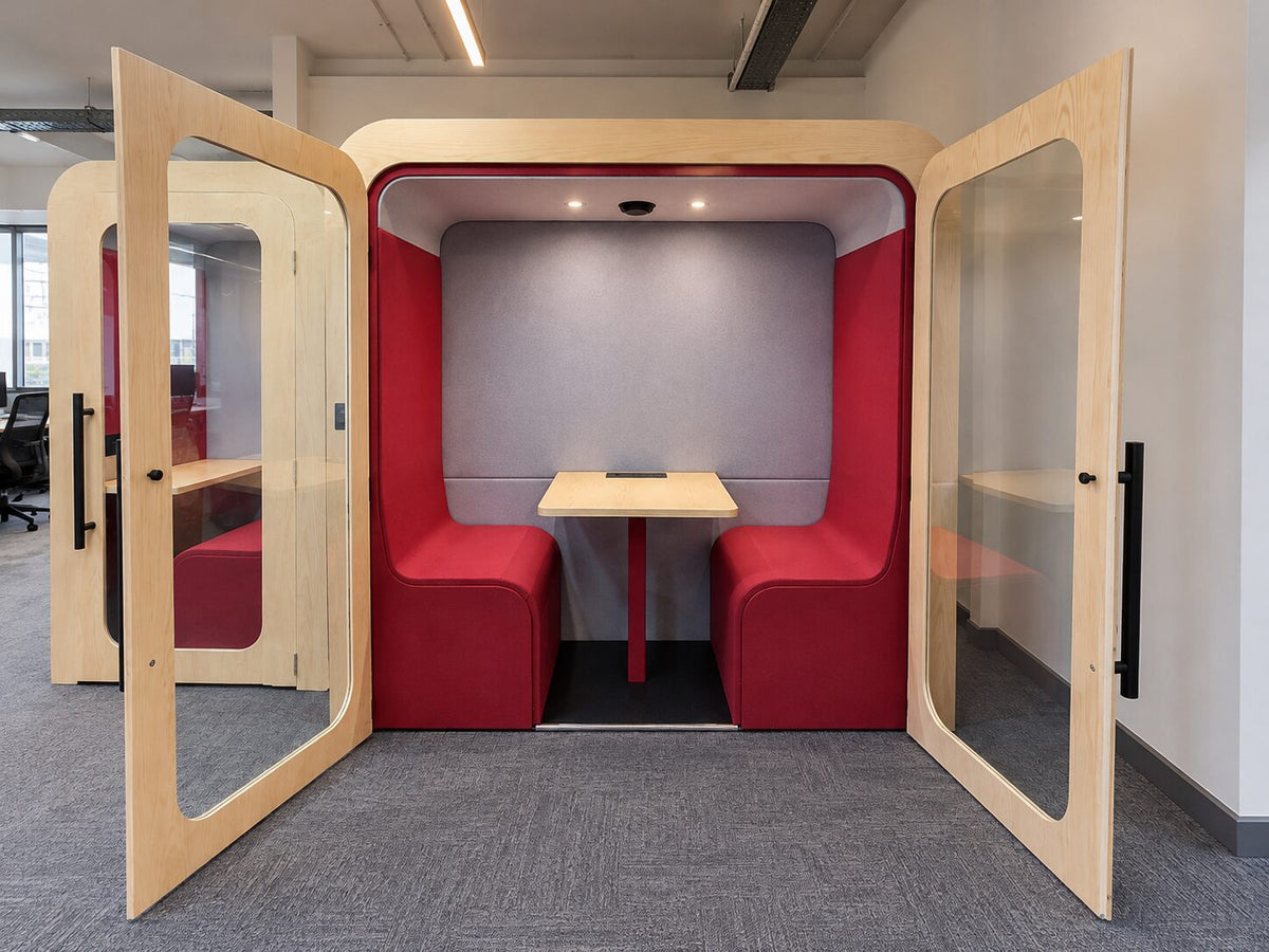 Dapapod four-person booth with red wool interior and doors open in an office