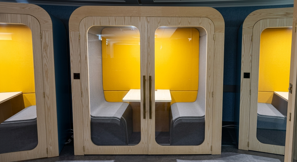 Row of Dapapod Double Office Pods with yellow interiors and grey seating