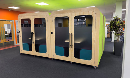 Two Dapapod Four Person Meeting Booths on wheels with frosted glass and green side panels